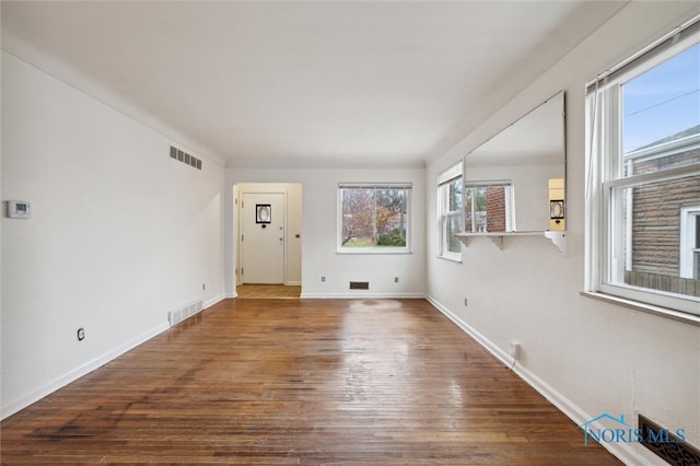 unfurnished room with wood-type flooring