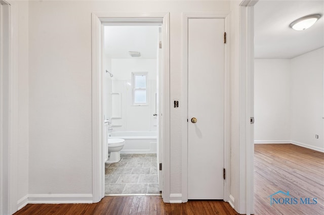 corridor with hardwood / wood-style floors