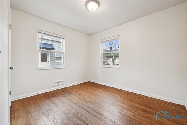 unfurnished room featuring hardwood / wood-style flooring