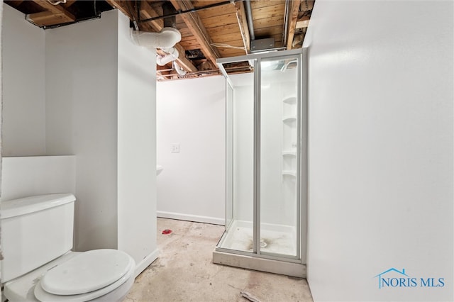 bathroom with concrete flooring and toilet