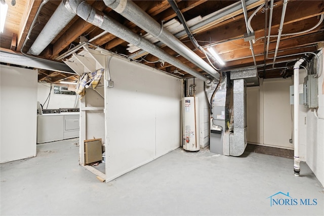 basement featuring heating unit, washer and dryer, and gas water heater