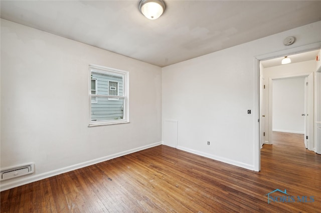 empty room with hardwood / wood-style floors