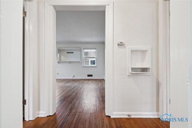 hallway featuring dark hardwood / wood-style flooring