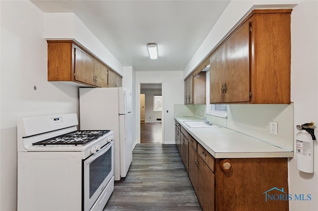 kitchen with dark hardwood / wood-style flooring and white gas range oven