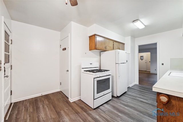 kitchen featuring white appliances, hardwood / wood-style flooring, ceiling fan, and sink