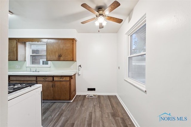 kitchen with white stove, hardwood / wood-style flooring, and ceiling fan