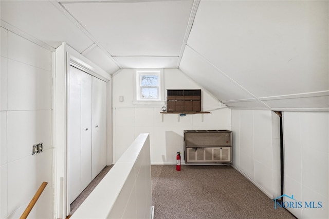 bonus room featuring carpet floors and vaulted ceiling