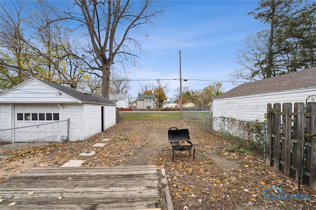 view of yard with a garage and an outdoor structure