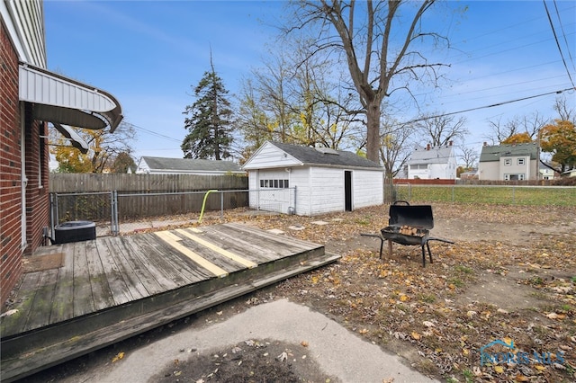 deck with area for grilling and an outbuilding