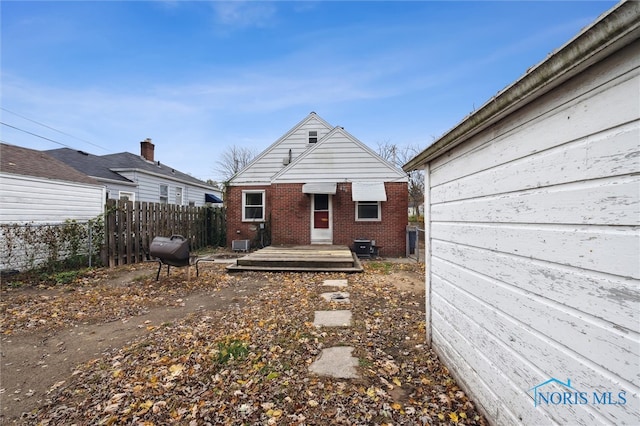 rear view of property featuring a wooden deck