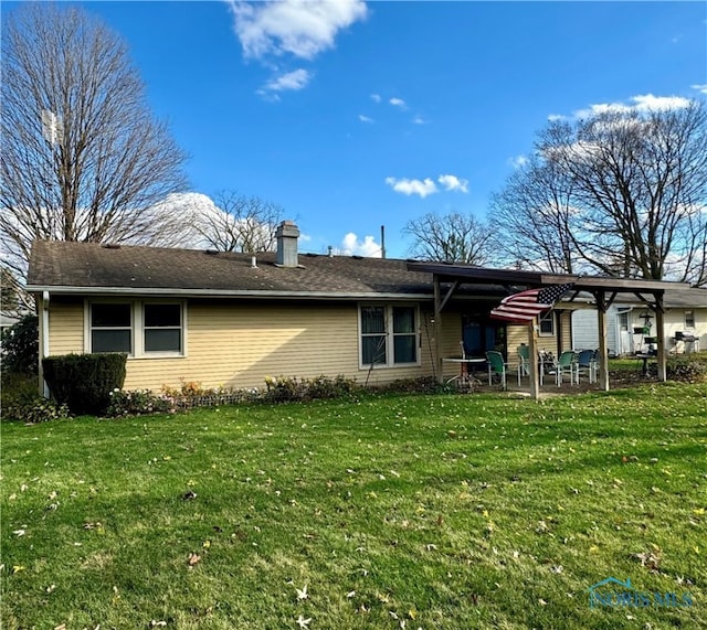 rear view of property with a patio area and a yard