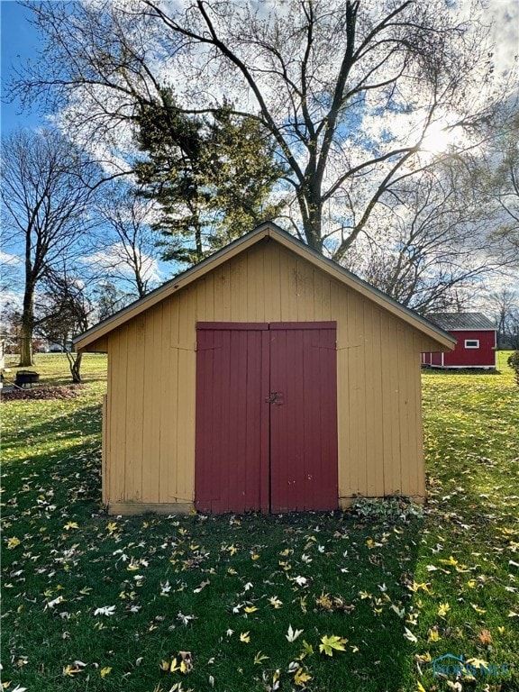 view of outbuilding with a lawn