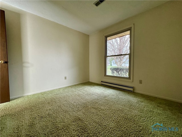 carpeted spare room with a baseboard radiator