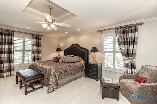 bedroom with ceiling fan, light colored carpet, and multiple windows