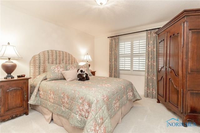 carpeted bedroom with ornamental molding