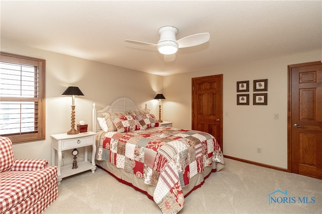 bedroom featuring ceiling fan and light carpet