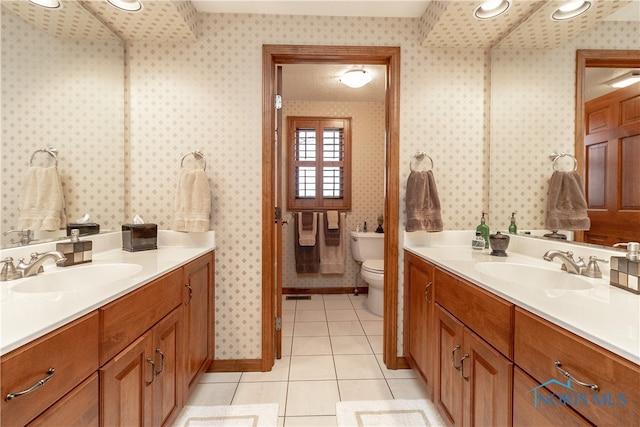 bathroom featuring tile patterned floors, vanity, and toilet