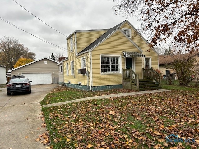 view of front of house featuring a garage and an outdoor structure