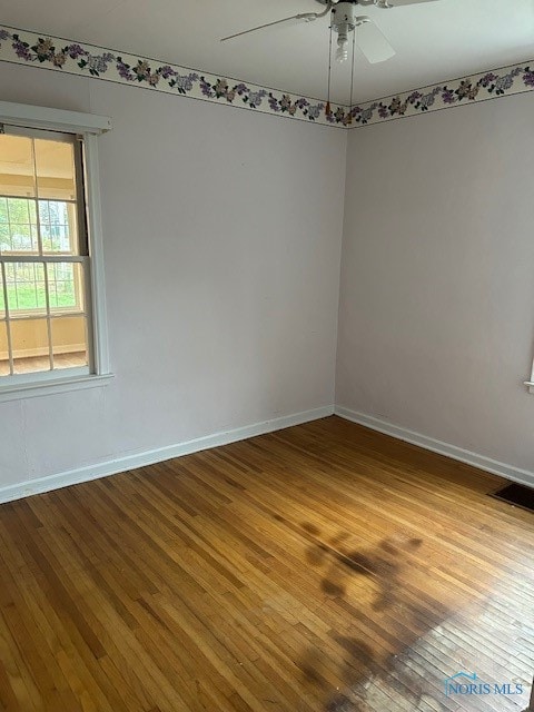 spare room with hardwood / wood-style flooring and ceiling fan