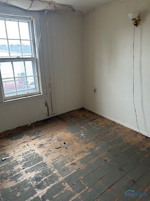 unfurnished room with dark hardwood / wood-style flooring