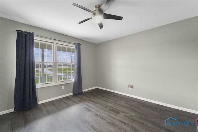 spare room with ceiling fan and dark hardwood / wood-style flooring