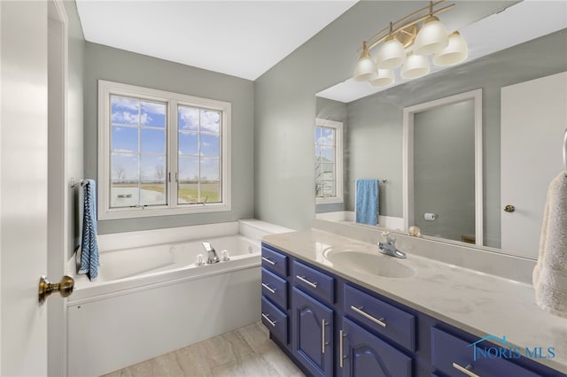 bathroom featuring vanity and a washtub