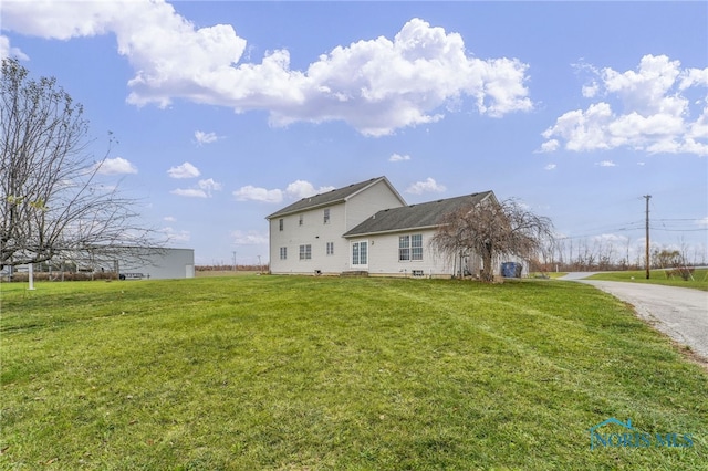 back of house featuring a lawn