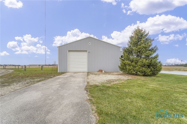 garage featuring a water view and a yard