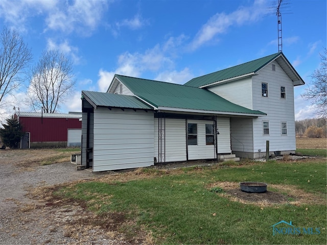 rear view of house with a yard