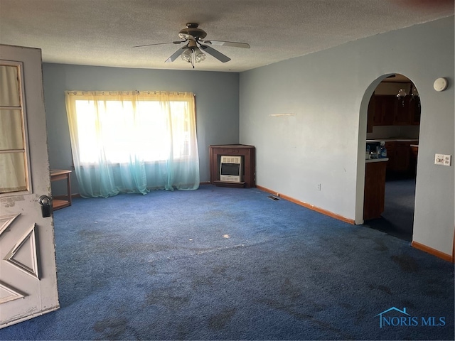 unfurnished living room with carpet, ceiling fan, a textured ceiling, and heating unit