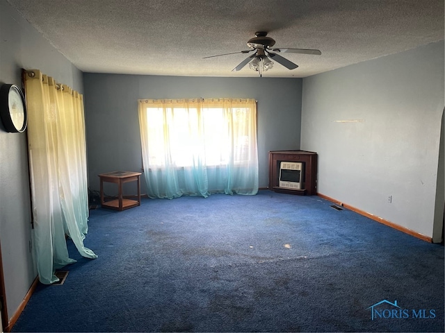 unfurnished living room with carpet flooring, a textured ceiling, heating unit, and ceiling fan