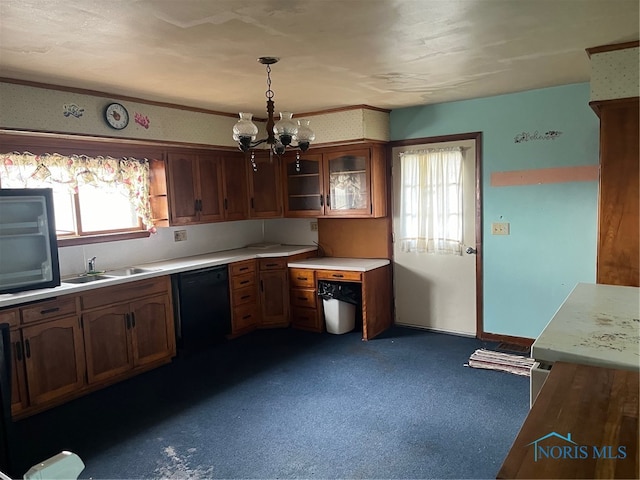 kitchen featuring sink, an inviting chandelier, hanging light fixtures, and black dishwasher