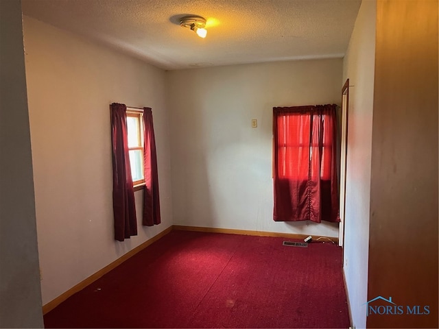 empty room with a textured ceiling