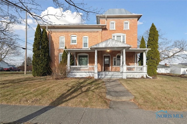 italianate-style house featuring covered porch and a front yard