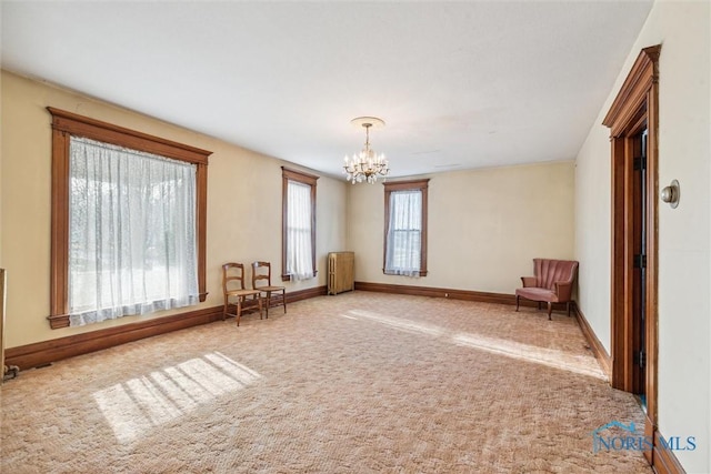 unfurnished room featuring a chandelier, carpet, and radiator