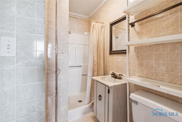 bathroom featuring a shower with shower curtain, tile patterned flooring, toilet, and tile walls