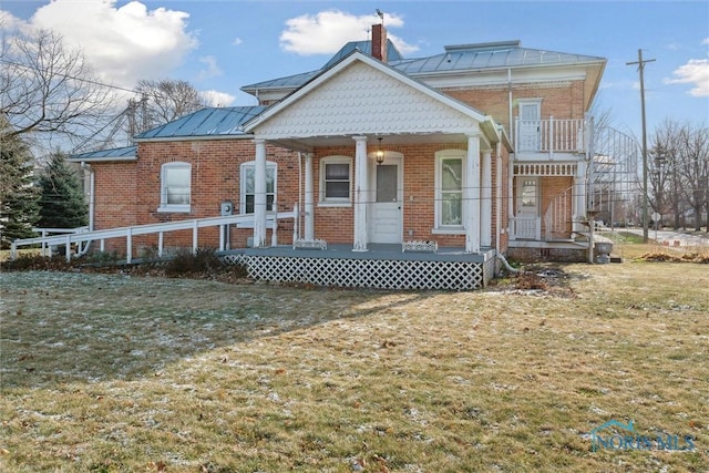 view of front of home with covered porch and a front lawn