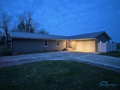 view of front of house with a garage and a front yard