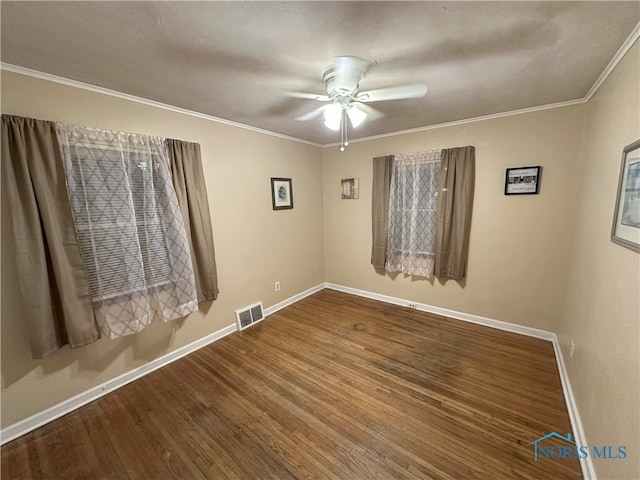 empty room with ceiling fan, crown molding, and wood-type flooring