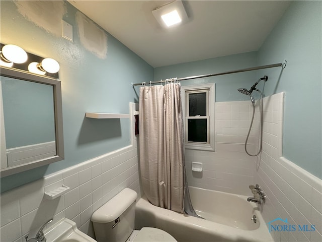 bathroom featuring toilet, tile walls, and shower / tub combo