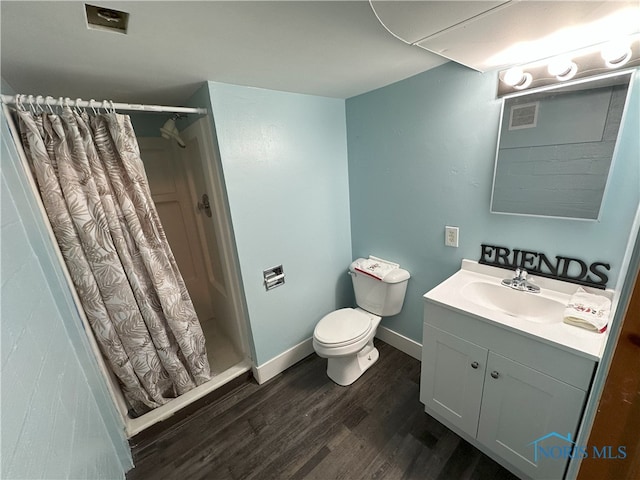 bathroom featuring a shower with curtain, toilet, vanity, and hardwood / wood-style flooring