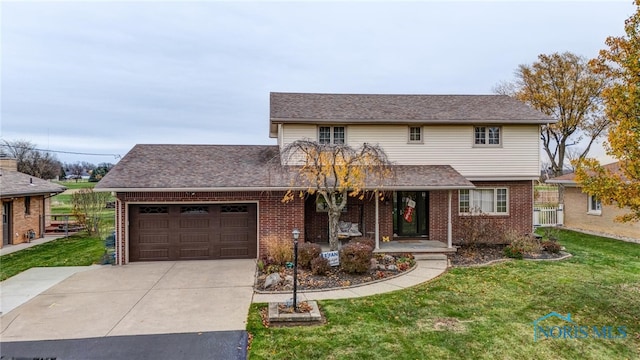 view of property with a porch, a front yard, and a garage