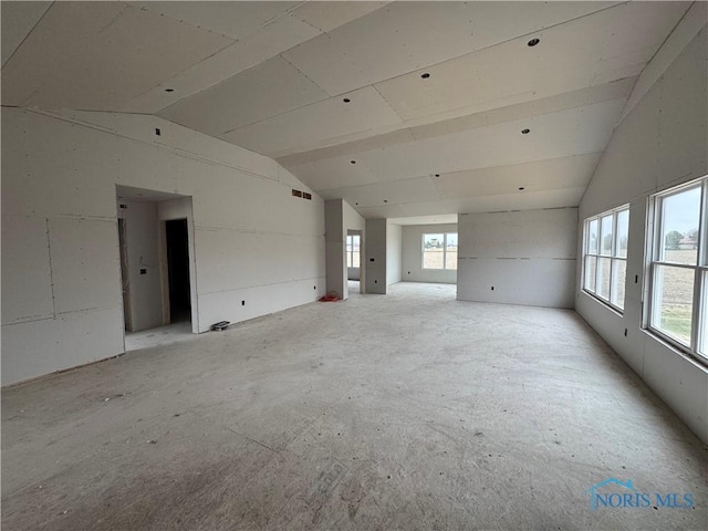 unfurnished room featuring vaulted ceiling