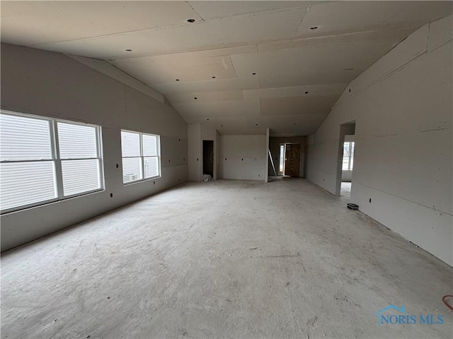 unfurnished living room with lofted ceiling