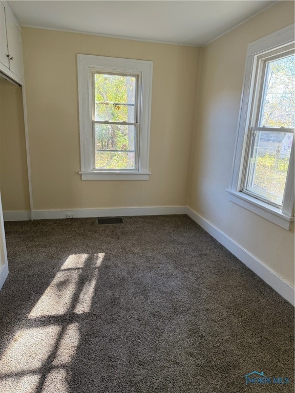 empty room with dark carpet