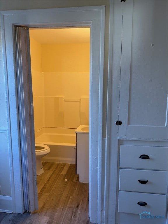 bathroom featuring hardwood / wood-style flooring, vanity, and toilet