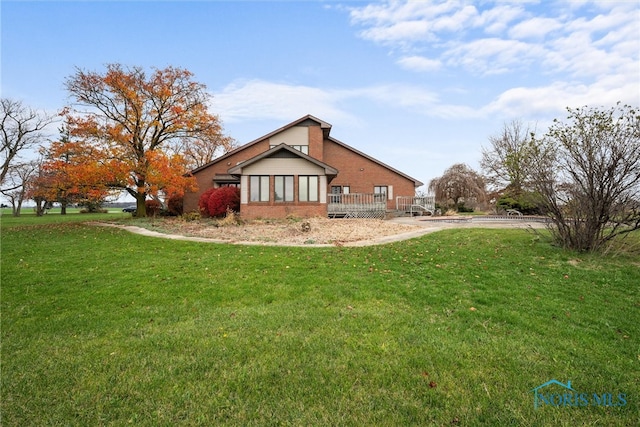 view of property exterior featuring a yard and a wooden deck