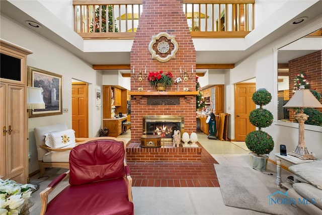 living room featuring a fireplace, a towering ceiling, and light colored carpet