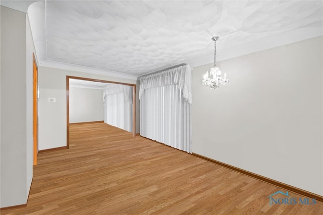 interior space featuring a chandelier and light wood-type flooring