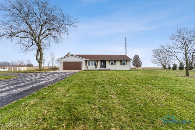 single story home with a garage and a front lawn